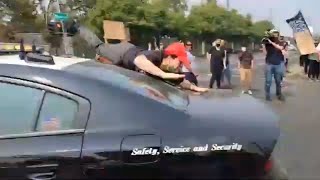 AntiTrump Protester Thrown From Police Vehicle as It Speeds Away From Sacramento Crowd [upl. by Magee]